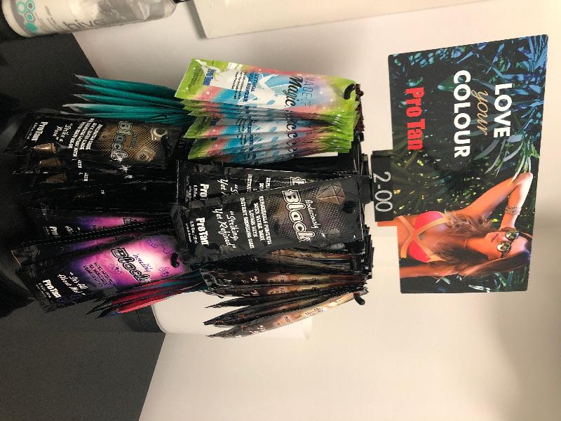 Sunbed cream sachets & display stand