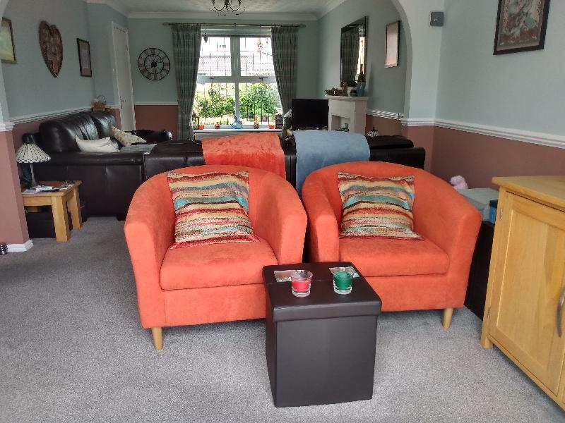 Well made tub chairs in lovely vibrant fabric.