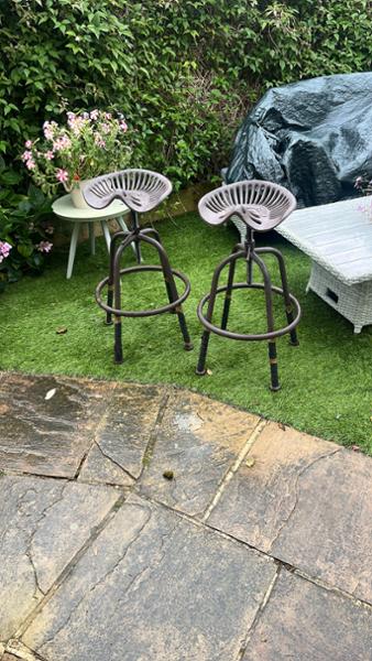 Cast iron tractor seat bar stools.