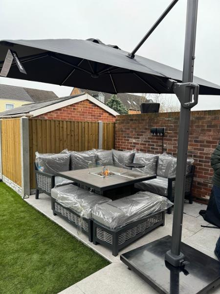 Corner patio set with fire and parasol with lights