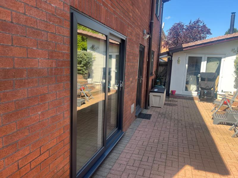 Anthracite on white A-rated windows, sliding patio door & front Solidor with side panels