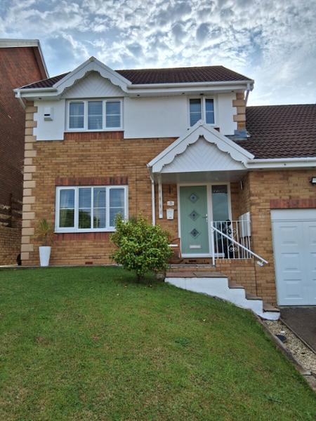 A-rated windows and Chartwell green on white solid core door with a fully glazed side panel