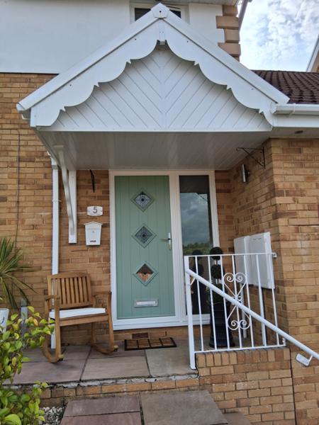 A-rated windows and Chartwell green on white solid core door with a fully glazed side panel