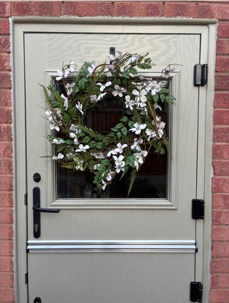 Lovely wreath and small arrangement in a glass vase