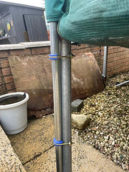 Trampoline safety net support poles.