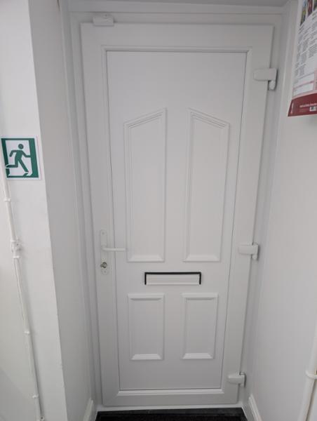 White on white uPVC door with split spindle handle