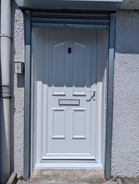 White on white uPVC door with split spindle handle