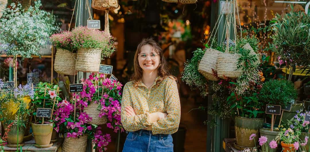 woman-smiling-in-front-of-flower-shop.jpg